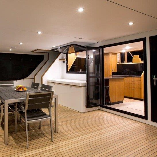 Motor yacht aft deck with folding glass doors