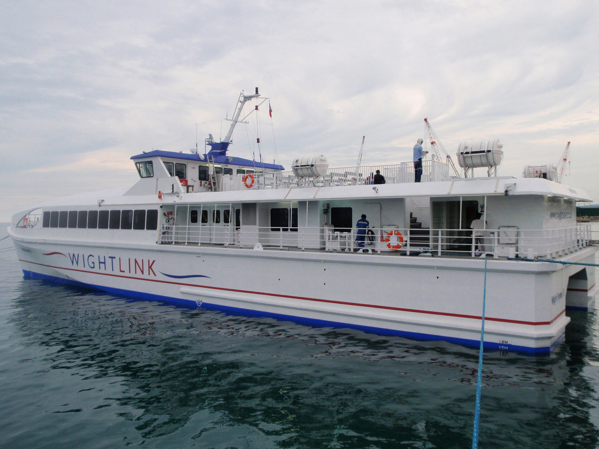 High-speed passenger catamaran ferry moored at the wharf